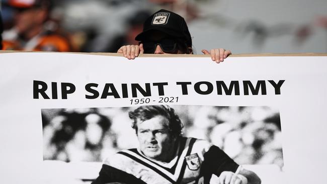 A fan holds up a tribute to the late Tommy Raudonikis on Sunday at Leichhardt Oval