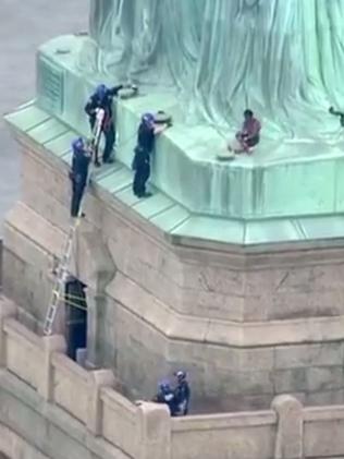 Statue of Liberty: Woman climbs the Statue of Liberty | news.com.au ...