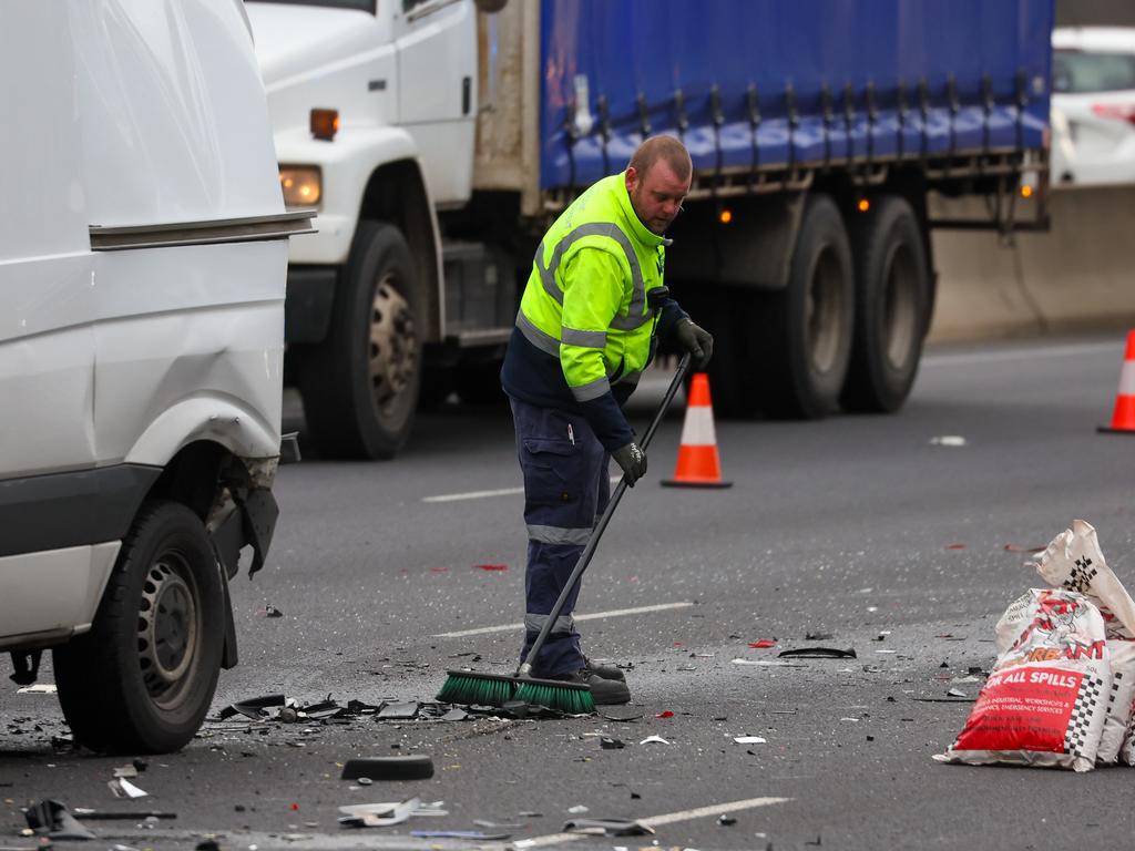 Authorities clear debris from the freeway. Picture: Brendan Beckett