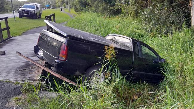 The black Ford ute abandoned in a ditch off McKinnon Drive, Tewantin, after crashing into a pedestrian bridge during suspected hooning. Photo: Paul Garratt.