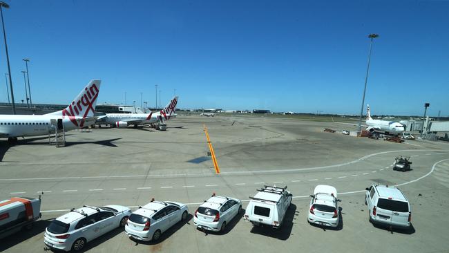 Airport vehicles and Virgin Australia planes on the tarmac at Brisbane Airport. Photo: David Clark