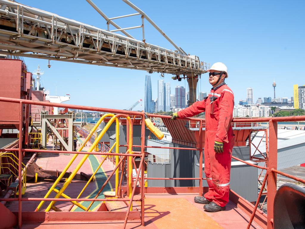 A worker unloads construction material shipped in from Adelaide at Glebe Island Port. Picture: Thomas Lisson