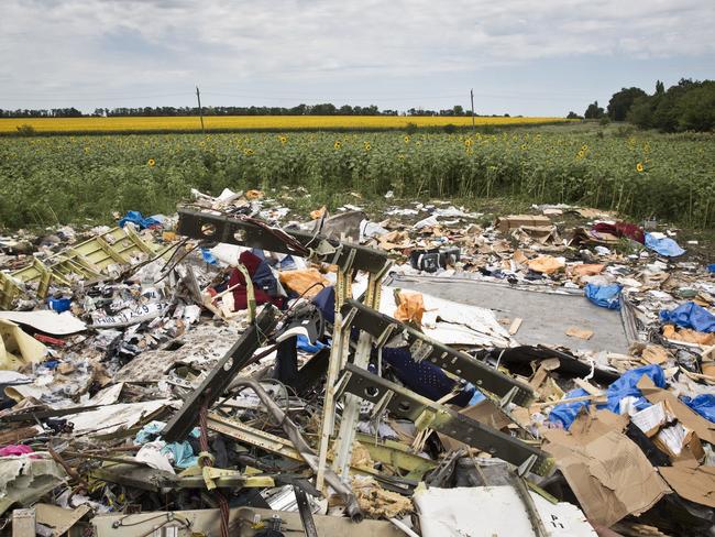 Debris and objects scattered on the ground where MH17 fell from the sky.