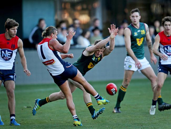 Tasmania's Mitchell Thorp attempts to smother a kick from NEAFL's Jordan Keras. Picture: PATRICK GEE