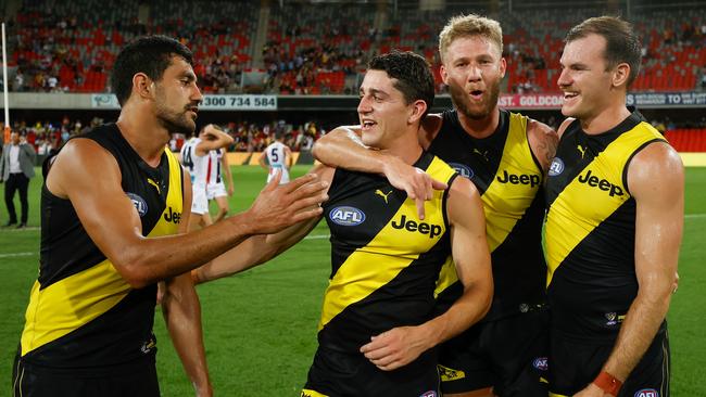 Kamdyn McIntosh, right, with teammates Marlion Pickett, Jason Castagna and Nathan Broad after the win over the Saints. Picture: Michael Willson/AFL Photos