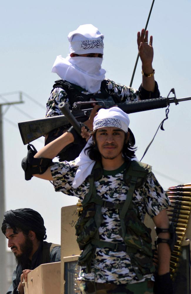 Taliban fighters atop an armoured vehicle parade along a road to celebrate after the US pulled all its troops out of Afghanistan, in Kandahar. Picture: JAVED TANVEER / AFP