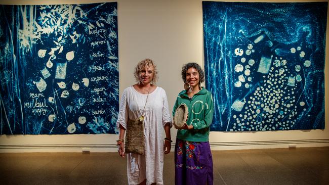 North Stradbroke Island artists, mother and daughter Sonja and Elisa Jane Carmichael with their work at the Tarnanthi: Open Hands exhibition, Art Gallery of SA. Picture: Matt Turner