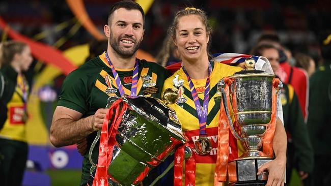 Australia's James Tedesco and Australia's Kezie Apps hold the winners' trophies as they pose for a photograph during the winner's presentation ceremony for the 2022 Rugby League World Cup. Photo by Oli SCARFF / AFP.