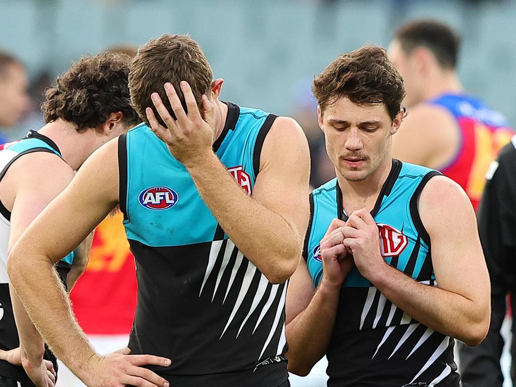 ADELAIDE, AUSTRALIA – JUNE 22: Mitch Georgiades of the Power and Jed McEntee react after the loss during the 2024 AFL Round 15 match between the Port Adelaide Power and the Brisbane Lions at Adelaide Oval on June 22, 2024 in Adelaide, Australia. (Photo by Sarah Reed/AFL Photos via Getty Images)