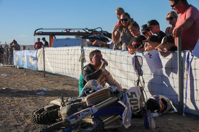 Finishing the 2019 Tatts Finke Desert Race was cause for an immediate celebratory drink for Cory Kennedy. Pic: MATT HENDERSON