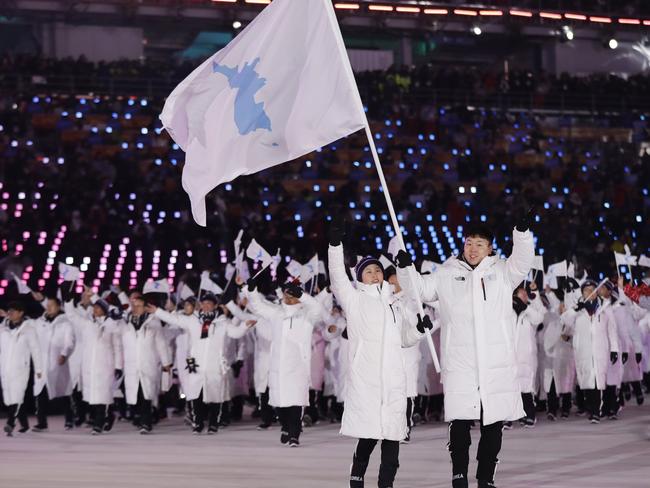 North Korea's Hwang Chung Gum and South Korea's Won Yun-jong hold the flag. Picture: AP Photo/Petr David Josek.