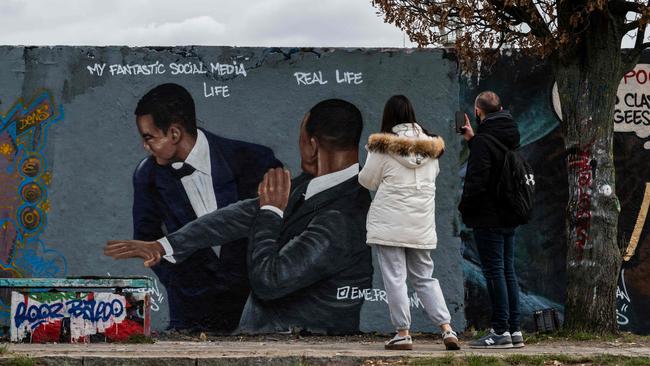 The slap heard around the world is now a street mural in Berlin. (Photo by John MACDOUGALL / AFP)