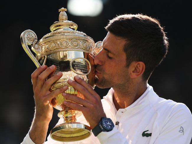 'Novak Djokovic kisses his trophy after defeating Nick Kyrgios at Wimbledon in July. Picture: AFP