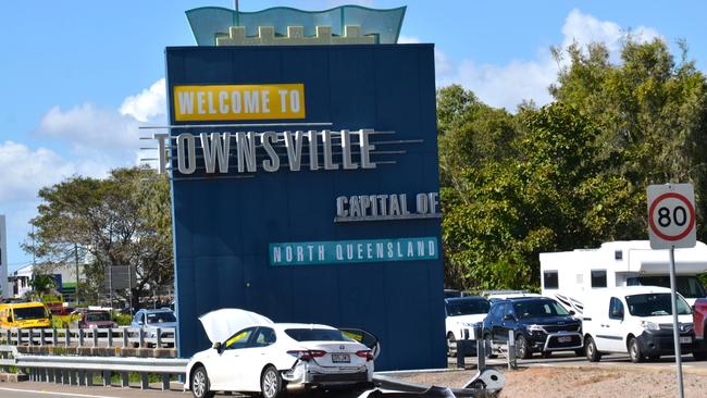 A stolen Toyota Camry crashed in front of the Welcome to Townsville sign on Woolcock St on Thursday. Picture: Natasha Emeck