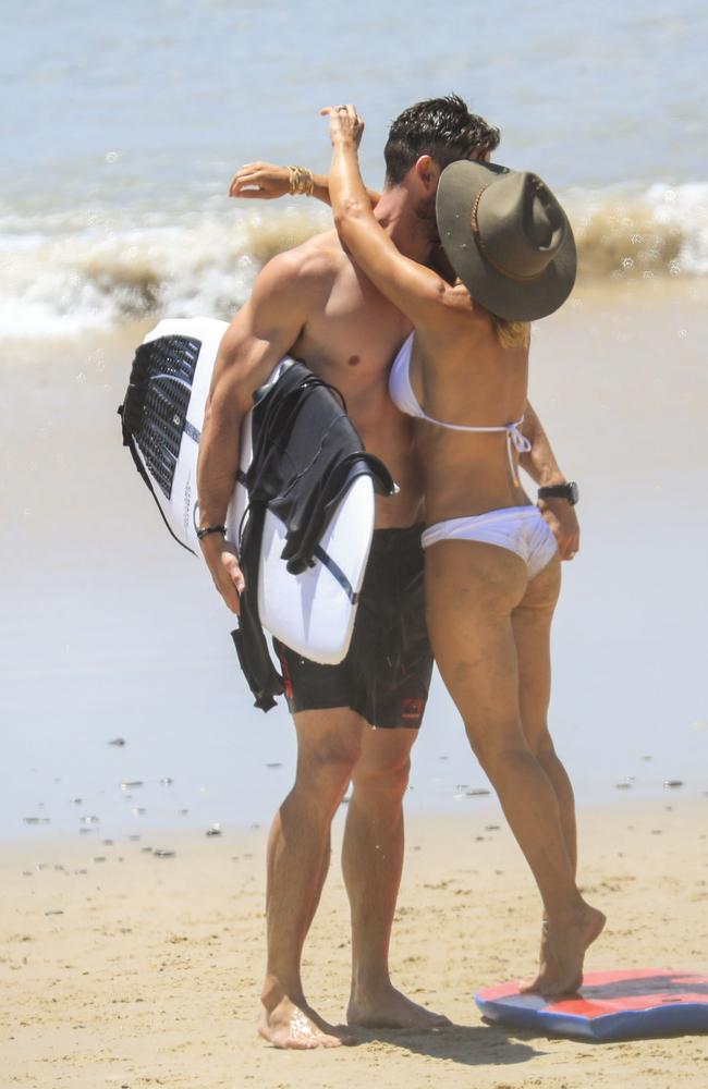 The couple couldn’t keep their hands off each other at the beach. Picture: Media Mode