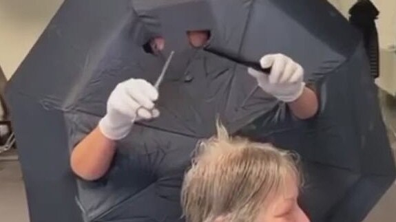 Coronavirus Hairdresser Cuts Holes Into Umbrella To Use When