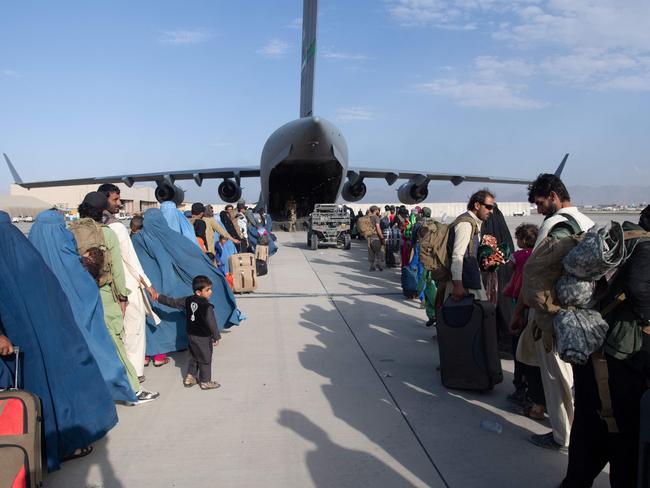 Evacuees being loaded aboard a US Air Force C-17 Globemaster III at Hamid Karzai International Airport. Picture: Donald R. Allen / US Air Force / AFP