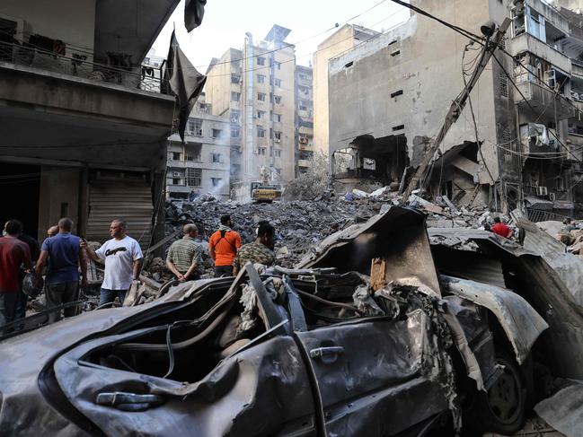 People gather at the site of an Israeli air strike in the Basta area, in Beirut, on October 11, 2024. Picture: AFP