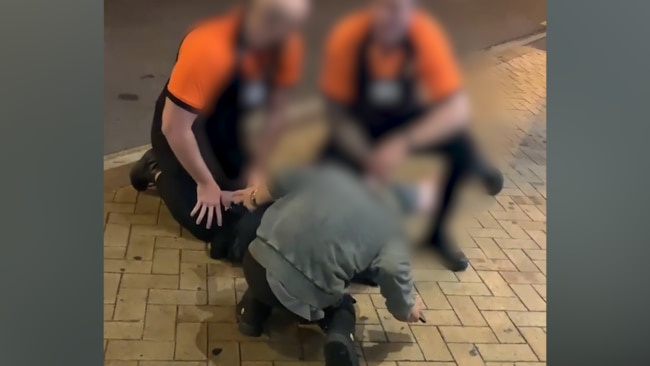 Security guards have been filmed slapping a man outside a Brisbane hotel.