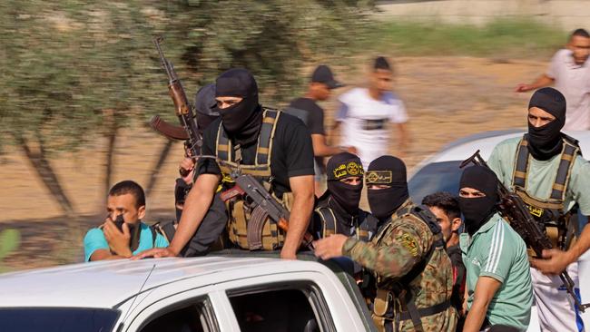 Palestinian militants move towards the border fence with Israel from Khan Yunis in the southern Gaza Strip.