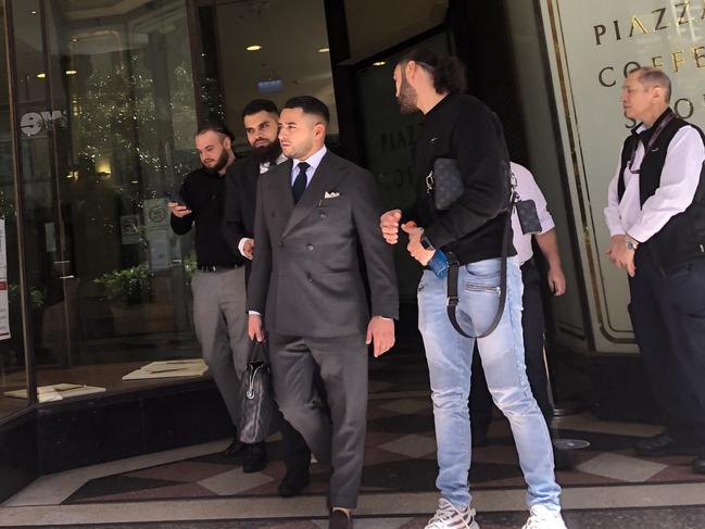 Ali Younes (far left) and Alameddine (front, wearing jeans) leave court with their lawyers on Monday