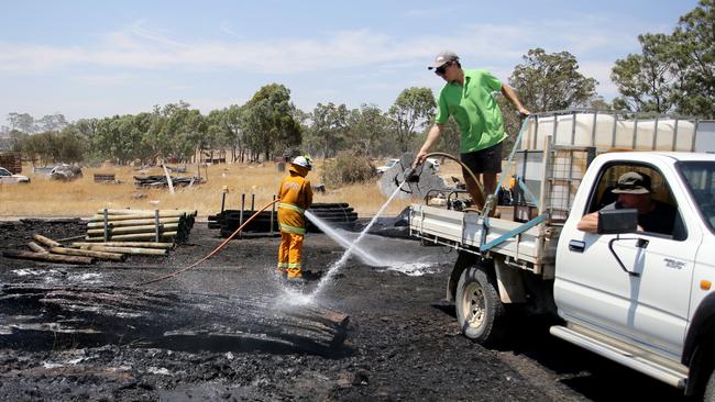 Farm units and CFS members put out a fire which reached hay bales on a property at Mount Torrens in the Adelaide Hills. Picture: AAP / Kelly Barnes