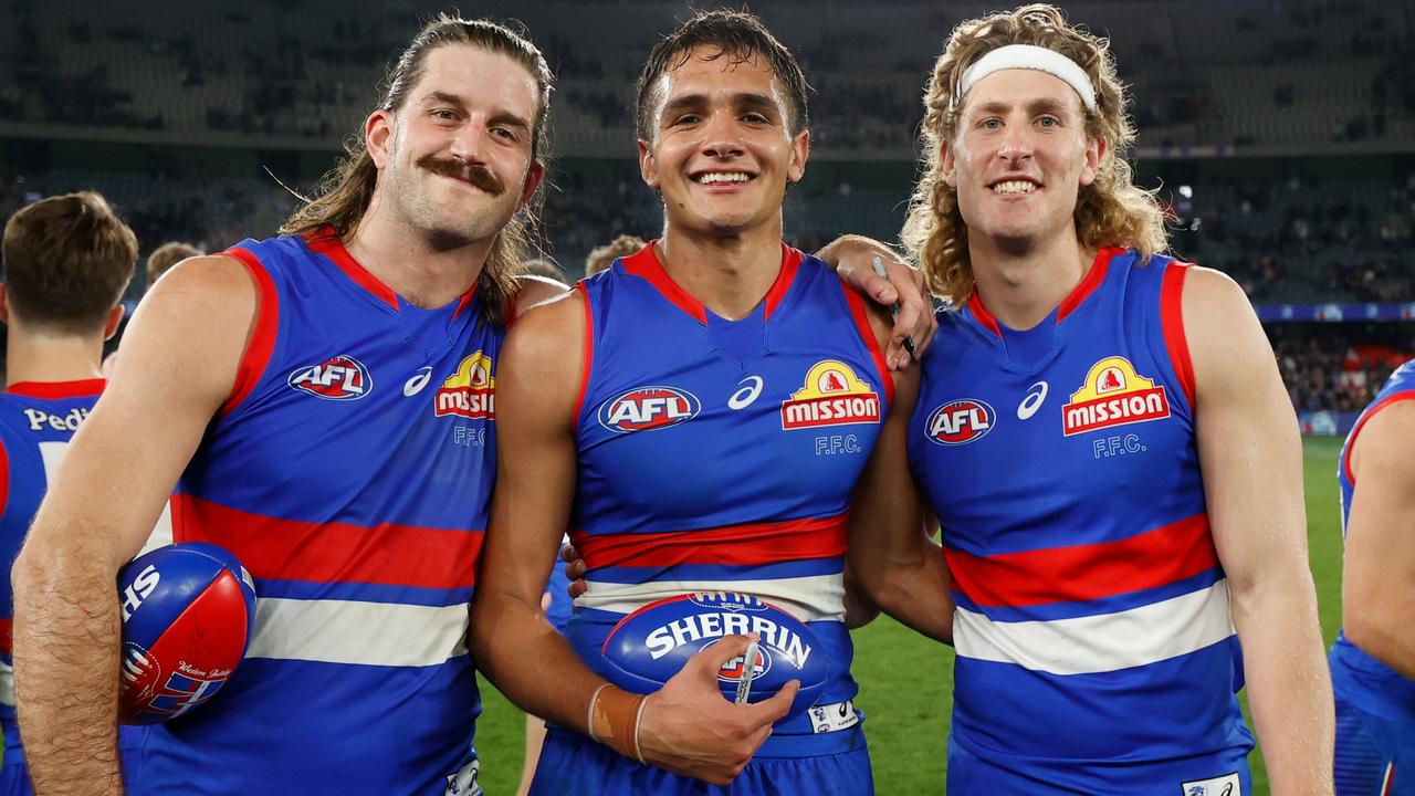 Josh Bruce and Aaron Naughton with man of the moment Jamarra Ugle-Hagan. Picture: Michael Willson/AFL Photos via Getty Images