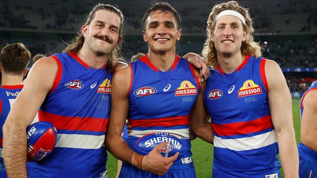 Josh Bruce and Aaron Naughton with man of the moment Jamarra Ugle-Hagan. Picture: Michael Willson/AFL Photos via Getty Images