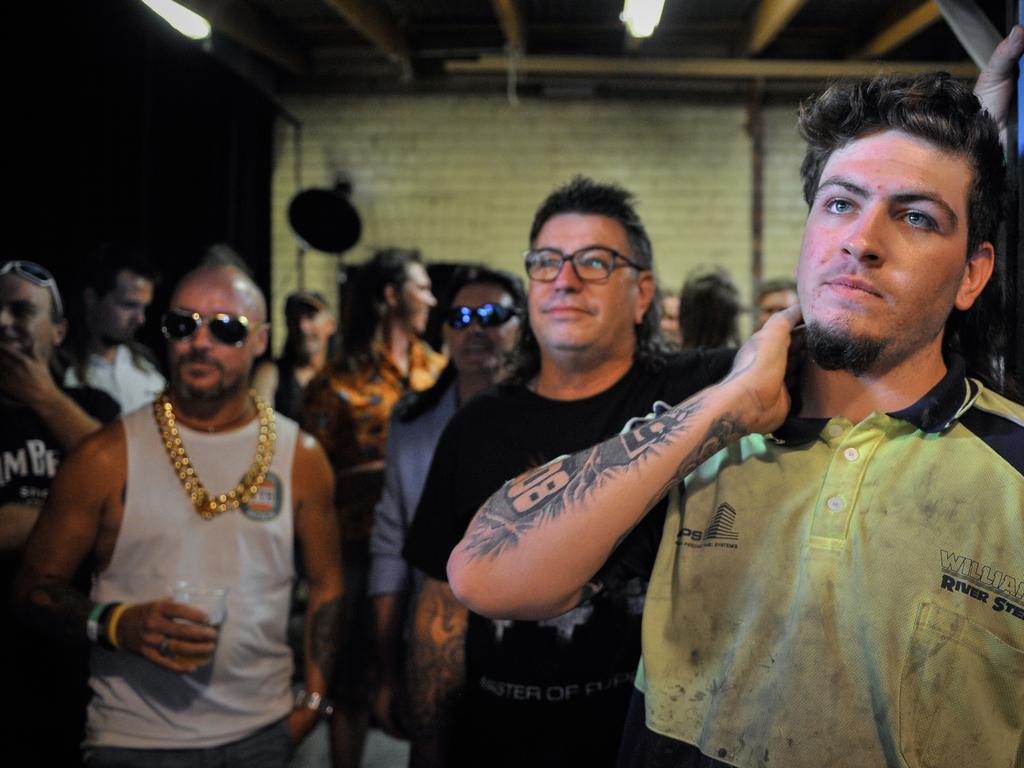 Participant Wally Madden waits to take the stage during Mulletfest, a special event designed to celebrate the hairstyle that's all about business at the front, party at the back, at Chelmsford Hotel in Kurri Kurri, NSW. (AAP Image/Perry Duffin) 