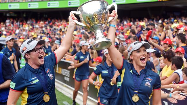 Bec Goddard and player Abbey Holmes show off the 2017 premiership cup at Adelaide Oval. Picture: Tom Huntley