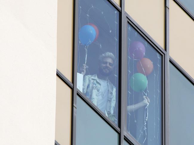 Jordan Bond watches his family from his Voco hotel room. Picture: Tertius Pickard.