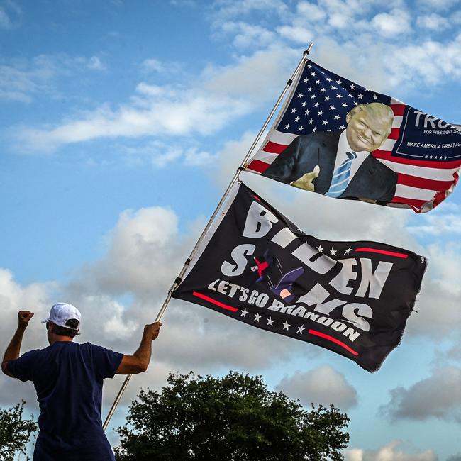 A supporter of Donald Trump waits to catch a glimpse of the US President near Palm Beach International Airport in West Palm Beach, Florida, on Wednesday. Picture: AFP