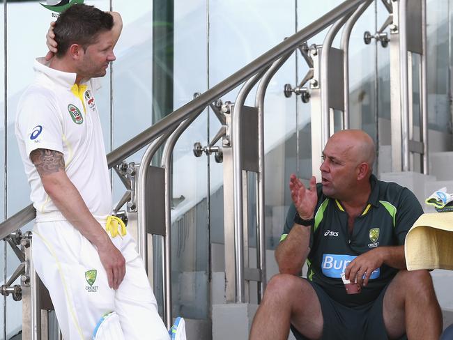 Australia captain Michael Clarke talks to coach Darren Lehmann.