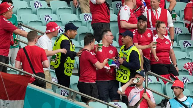 Stewards intervene on a Denmark supporter who was holding up a rainbow flag before the UEFA EURO 2020 quarter-final football match between the Czech Republic and Denmark at the Olympic Stadium in Baku. Picture: AFP