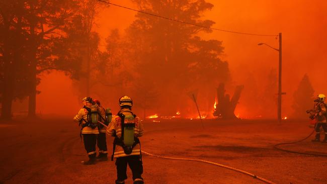 Firefighters confront a hellscape in Balmoral, south west of Sydney. Most of the town is believed to have been destroyed by fire this weekend. Picture: Sam Ruttyn