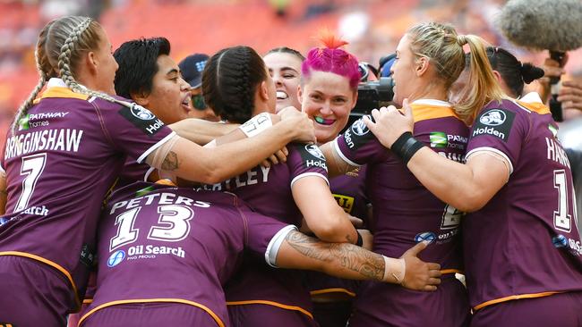 Chelsea Baker (centre) celebrates scoring a try with her Broncos teammates during the NRL Women's clash against the Dragons at Suncorp Stadium. Picture: AAP