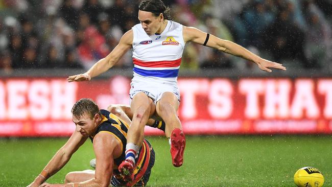 Daniel Talia of the Adelaide Crows slides and takes out Lukas Webb of the Bulldogs.