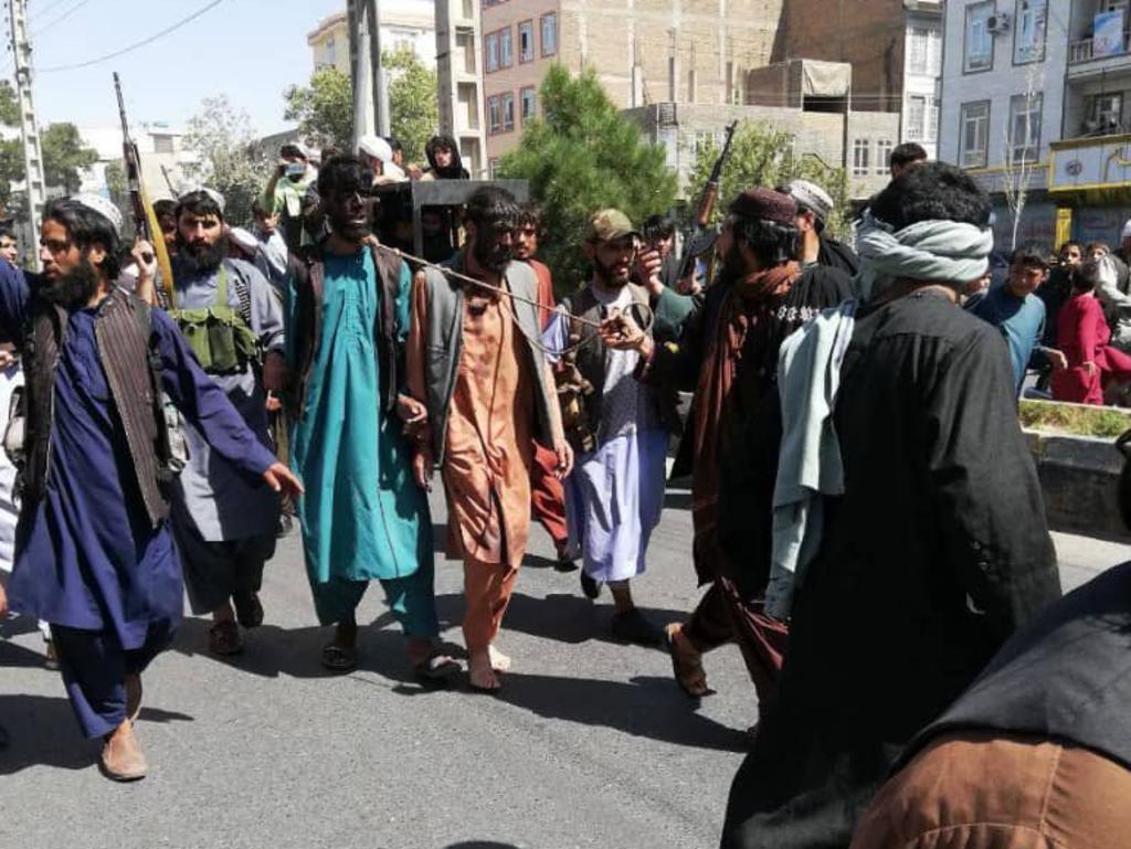 Two men are dragged by rope by Taliban militants in Afghanistan.