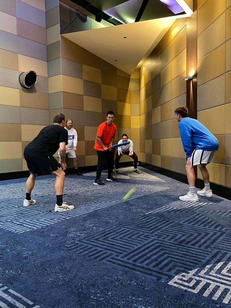 Brisbane players work on their indoor cricket skills in the team hotel.