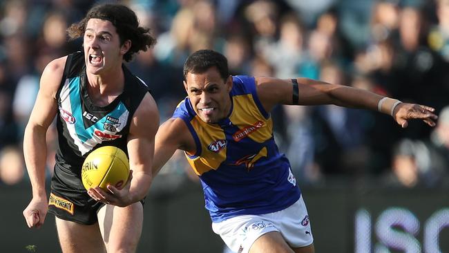 Darcy Byrne-Jones of the Power is tackled by Josh Hill of the Eagles.