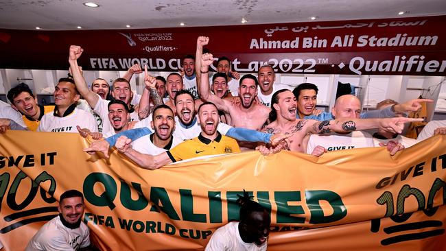 Australia celebrates their win over Peru in the changing room. Photo by Joe Allison/Getty Images.