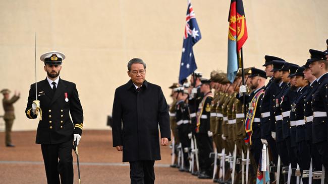 Premier Li inspects a guard of honour during an official welcome ceremony on the forecourt of Parliament House in Canberra. Picture: AFP