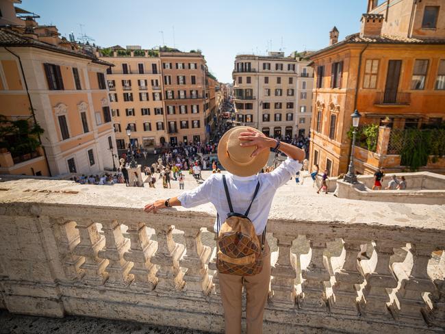 Woman standing in the Spanish Steps in Rome, Italy viewed from above Trinità dei Monti