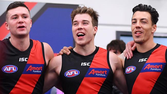 Conor McKenna (left) sings the Bombers’ song with Zach Merrett and Dylan Shiel after Friday night’s win over Hawthorn. Picture: Getty Images