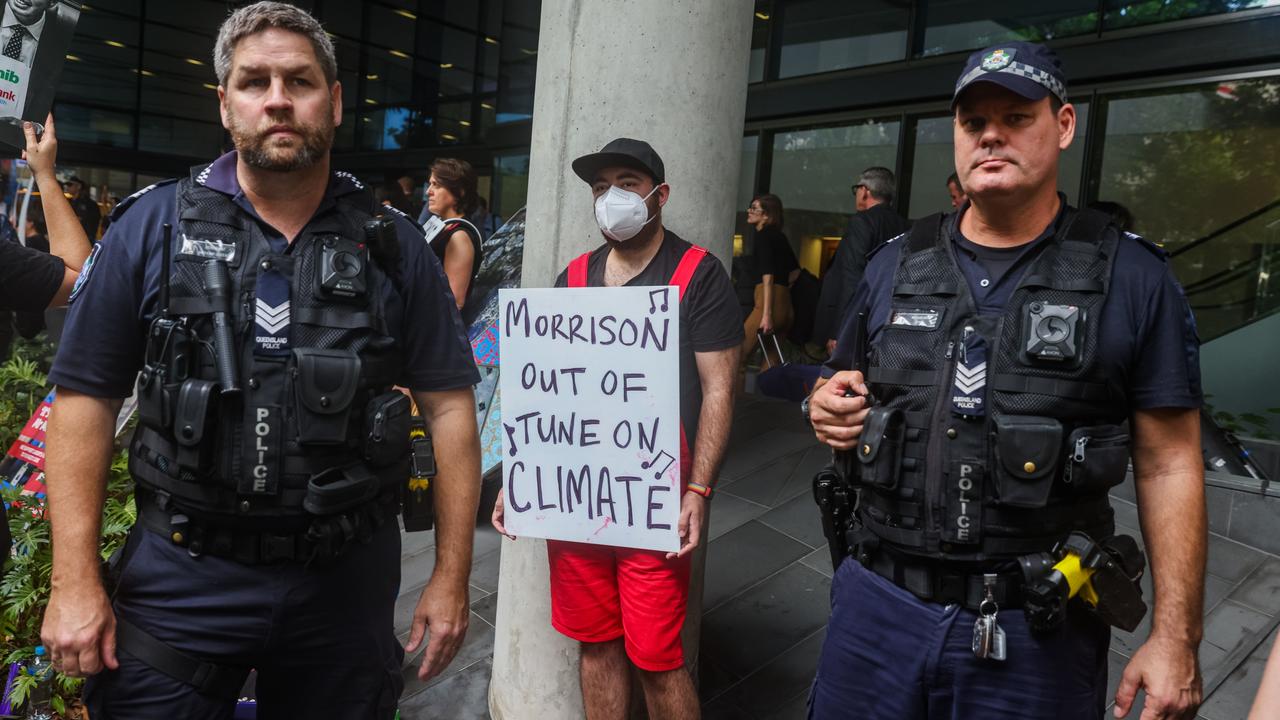 A protester holds a placard outside the Liberal Party election campaign launch in Brisbane. Picture: Asanka Ratnayake/Getty