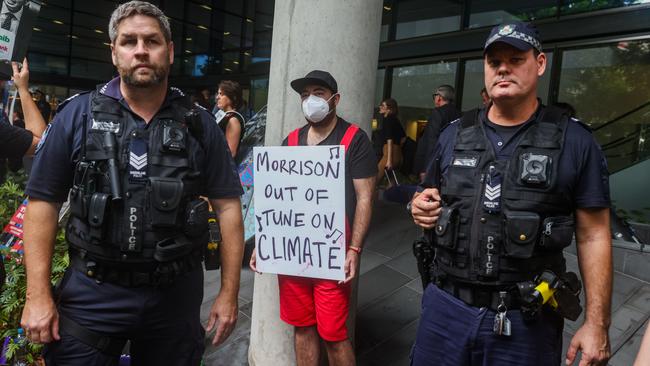 A protester holds a placard outside the Liberal Party election campaign launch in Brisbane. Picture: Asanka Ratnayake/Getty