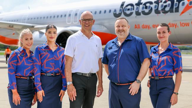 Jetstar cabin crew unveil the airline's new uniforms with Cairns Airport chief executive Richard Barker (centre) ahead of Jetstar's inaugural flight service from Cairns to the Sunshine Coast. Photo: Supplied.