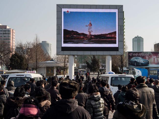 People in Pyongyang watching a public broadcast about the launch of a surface-to-surface medium long-range ballistic missile Pukguksong-2 at an undisclosed location in February. Picture: AFP