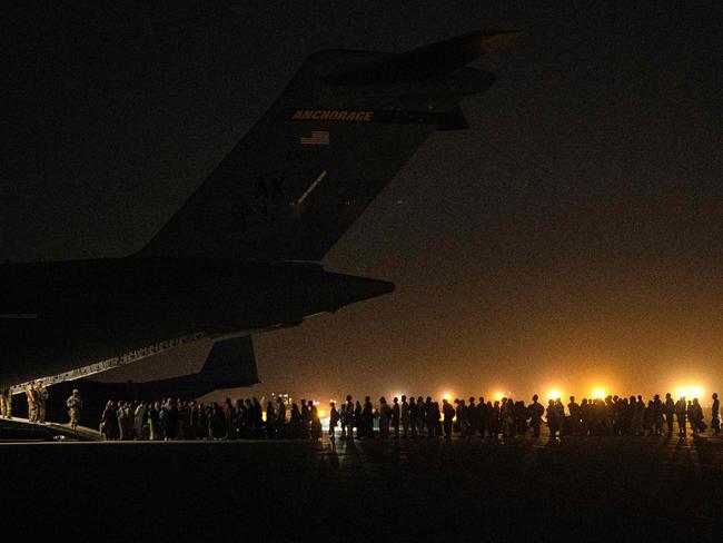 TOPSHOT - In this image courtesy of the US Central Command Public Affairs, Afghans civilians are evacuated by the US military on August 19, 2021, at an undisclosed location. - A Pentagon official confirmed Friday that US evacuation operations from Kabul's airport have been stalling because the receiving base in Qatar is overflowing and could not receive evacuees. "There has been a considerable amount of time todayâ¦ where there haven't been departures," Brigadier General Dan DeVoe of the US Air Mobility Command told reporters. (Photo by Brandon CRIBELAR / US Central Command Public Affairs / AFP) / RESTRICTED TO EDITORIAL USE - MANDATORY CREDIT "AFP PHOTO / US Air Force / Staff Sgt. Brandon Cribelar" - NO MARKETING - NO ADVERTISING CAMPAIGNS - DISTRIBUTED AS A SERVICE TO CLIENTS