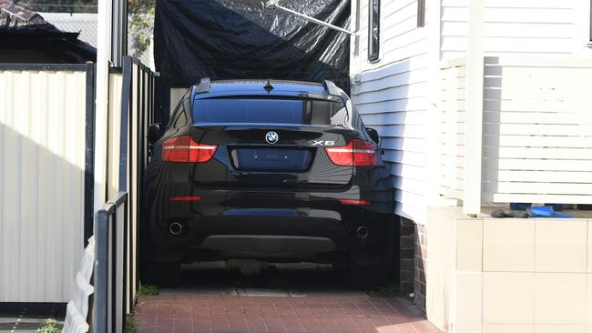 A car is seen in the driveway of a home where police earlier made a raid in Beverly Hills Picture: AAP Image/Brendan Esposito